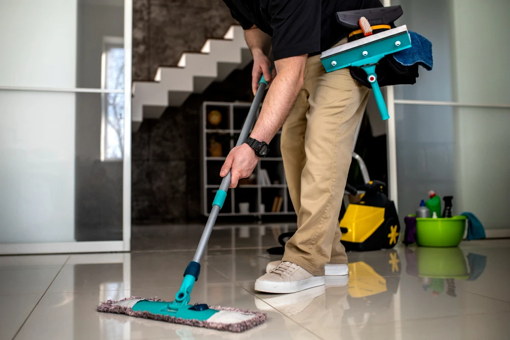 Residential house cleaning in Edmonton - Services Pro cleaner mopping the floor of an Edmonton home